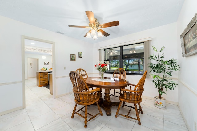 dining area featuring light tile patterned floors, a ceiling fan, visible vents, and baseboards