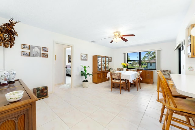 dining area with light tile patterned flooring, visible vents, and ceiling fan