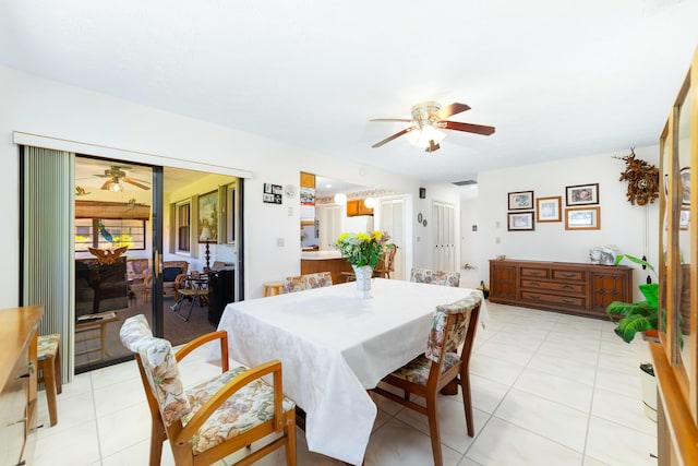 dining space featuring light tile patterned flooring and a ceiling fan