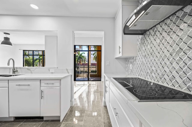 kitchen featuring ventilation hood, black electric cooktop, white cabinets, and a sink