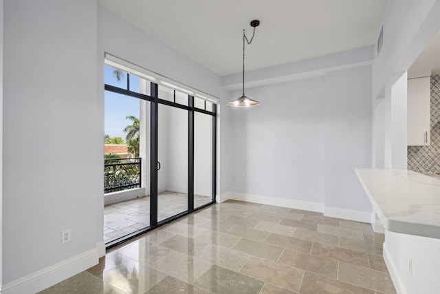 unfurnished dining area with visible vents and baseboards