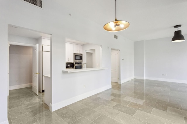 interior space with visible vents, appliances with stainless steel finishes, white cabinets, and light countertops