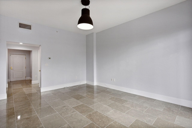 unfurnished room featuring visible vents and baseboards