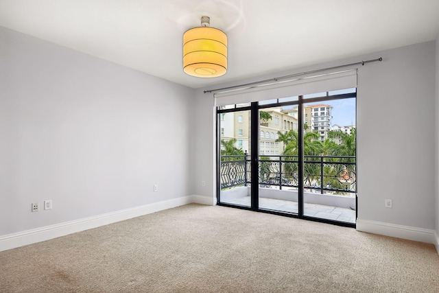 carpeted spare room with baseboards