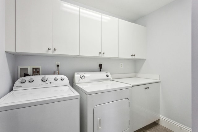 laundry room featuring cabinet space, independent washer and dryer, and baseboards