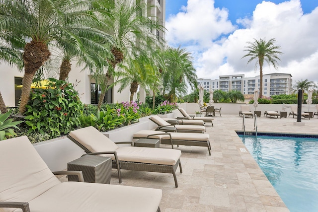 community pool with a patio and an outdoor living space