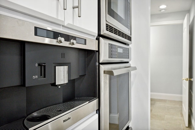 kitchen with appliances with stainless steel finishes and baseboards