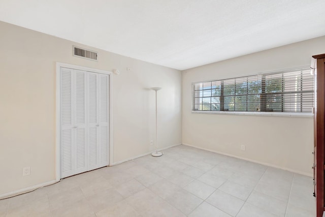 unfurnished bedroom with visible vents and baseboards