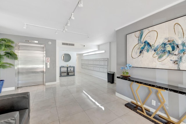 hallway featuring baseboards, visible vents, mail area, elevator, and tile patterned floors