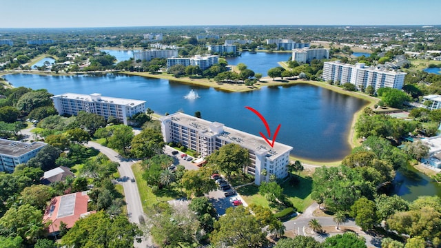 drone / aerial view with a city view and a water view