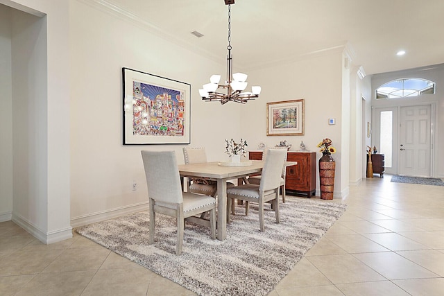 dining space with light tile patterned floors, visible vents, an inviting chandelier, and ornamental molding