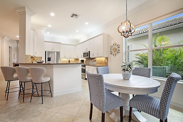 dining room with visible vents, a notable chandelier, recessed lighting, crown molding, and light tile patterned floors