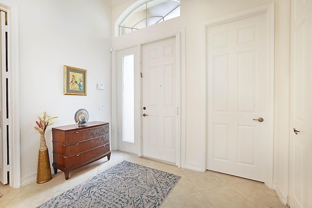 foyer featuring light tile patterned flooring and a healthy amount of sunlight