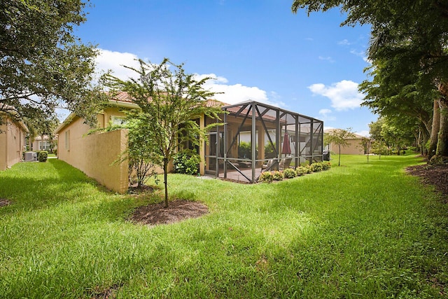 view of yard featuring glass enclosure and cooling unit