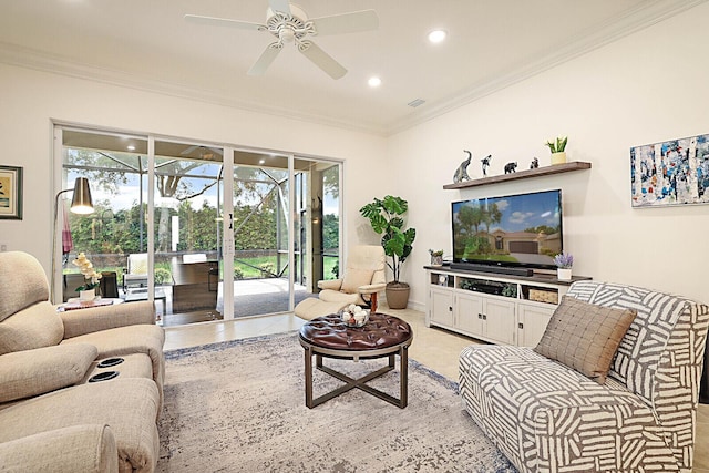 living room with visible vents, plenty of natural light, ceiling fan, and crown molding