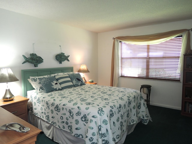 bedroom with baseboards and a textured ceiling