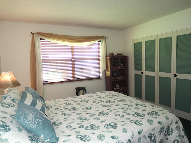 bedroom with a closet and a textured ceiling