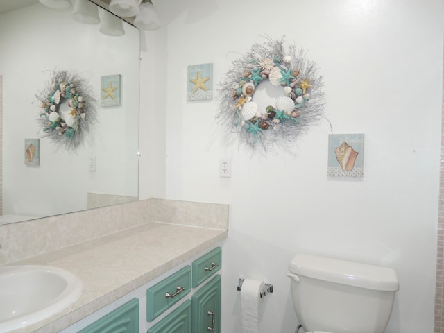 bathroom with toilet and vanity