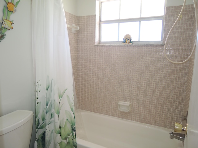 full bathroom with shower / bath combination with curtain and toilet