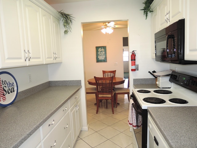 kitchen with light tile patterned flooring, white cabinetry, electric stove, and black microwave