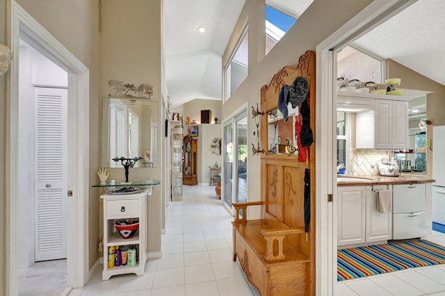 6089 Bay Isles Dr, Boynton Beach, FL 33437 - hallway with light tile patterned floors and lofted ceiling