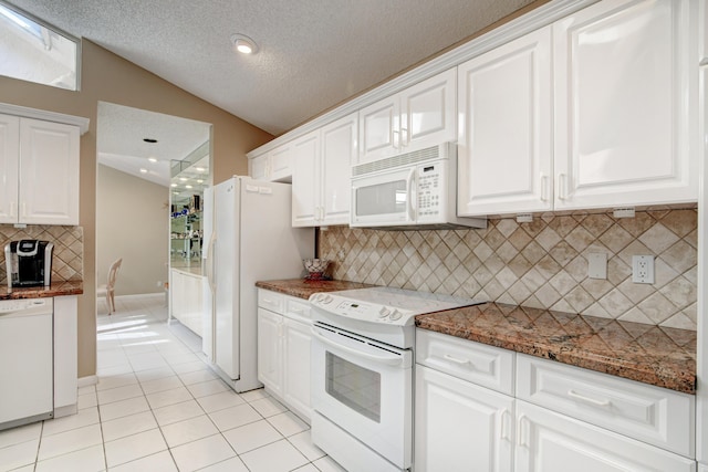 kitchen featuring light tile patterned floors, white appliances, and white cabinets