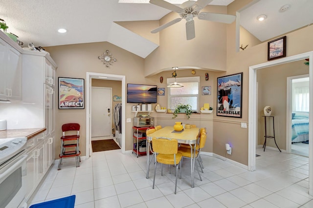 6089 Bay Isles Dr, Boynton Beach, FL 33437 - dining space with light tile patterned floors, baseboards, a ceiling fan, and vaulted ceiling