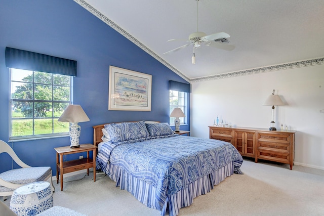 bedroom featuring lofted ceiling, multiple windows, a ceiling fan, and carpet floors