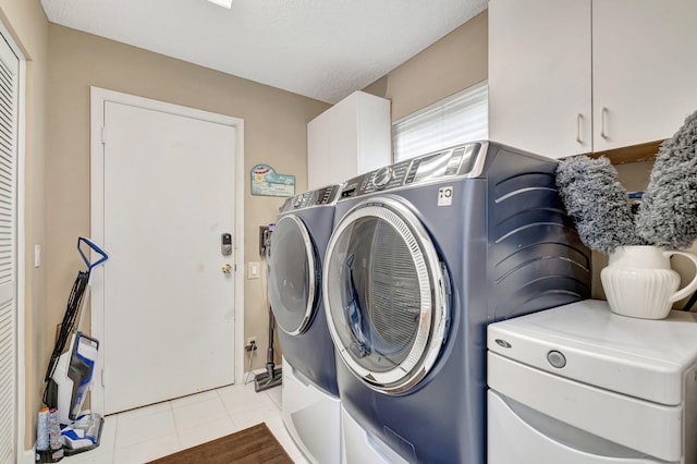 6089 Bay Isles Dr, Boynton Beach, FL 33437 - washroom featuring washing machine and dryer, light tile patterned floors, and cabinet space