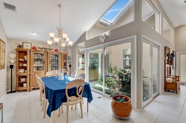 6089 Bay Isles Dr, Boynton Beach, FL 33437 - dining area featuring lofted ceiling with skylight, light tile patterned floors, visible vents, and a chandelier