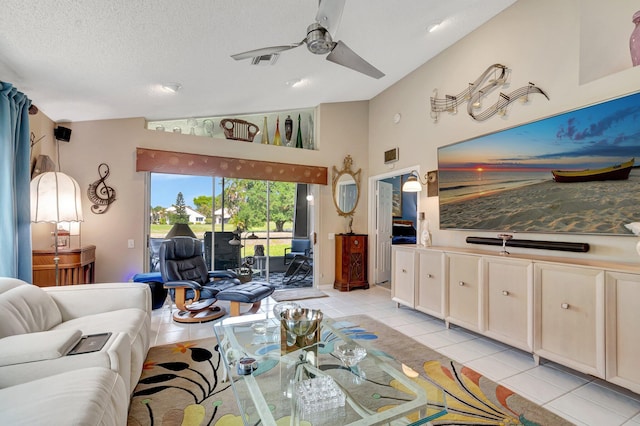 6089 Bay Isles Dr, Boynton Beach, FL 33437 - living area with visible vents, lofted ceiling, light tile patterned floors, a textured ceiling, and a ceiling fan