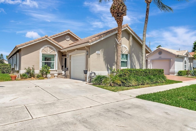 6089 Bay Isles Dr, Boynton Beach, FL 33437 - mediterranean / spanish-style home with a tiled roof, a garage, driveway, and stucco siding