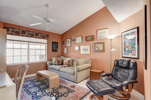 tiled living room featuring baseboards, lofted ceiling, a textured ceiling, and a ceiling fan