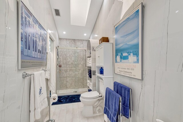 6089 Bay Isles Dr, Boynton Beach, FL 33437 - bathroom with a shower stall, toilet, tile walls, and visible vents