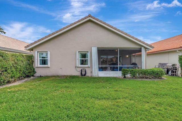 6089 Bay Isles Dr, Boynton Beach, FL 33437 - back of house featuring a tile roof, a yard, a sunroom, and stucco siding