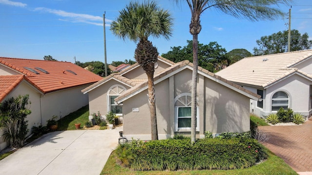6089 Bay Isles Dr, Boynton Beach, FL 33437 - view of home's exterior featuring a tiled roof, driveway, and stucco siding