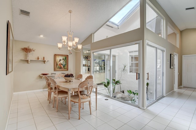 dining area featuring light tile patterned floors, visible vents, high vaulted ceiling, and a notable chandelier