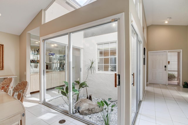 interior space with recessed lighting, high vaulted ceiling, and light tile patterned flooring