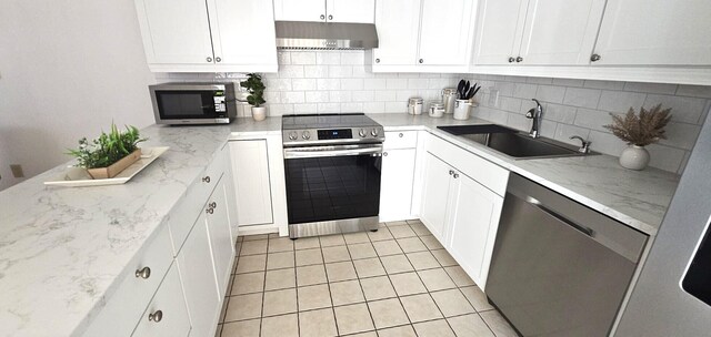 335 S Waverly Pl Unit 7A, Vero Beach, FL 32960 - kitchen with a sink, decorative backsplash, under cabinet range hood, and stainless steel appliances