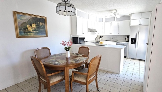 335 S Waverly Pl Unit 7A, Vero Beach, FL 32960 - dining area featuring light tile patterned floors, a textured ceiling, and a ceiling fan