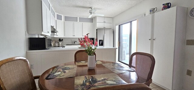 335 S Waverly Pl Unit 7A, Vero Beach, FL 32960 - dining space featuring a textured ceiling and a ceiling fan
