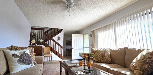 335 S Waverly Pl Unit 7A, Vero Beach, FL 32960 - living room featuring carpet flooring, stairway, a textured ceiling, and a ceiling fan