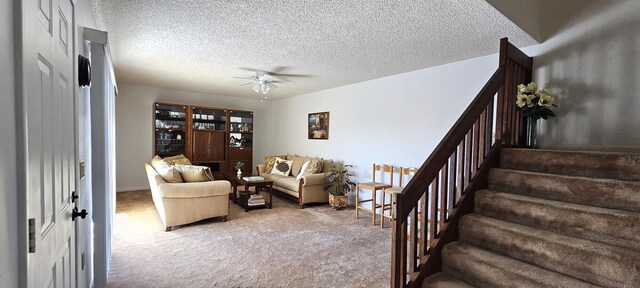 335 S Waverly Pl Unit 7A, Vero Beach, FL 32960 - living area featuring stairway, a ceiling fan, light colored carpet, and a textured ceiling