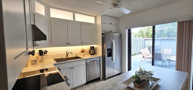 335 S Waverly Pl Unit 7A, Vero Beach, FL 32960 - kitchen with a ceiling fan, a sink, light countertops, appliances with stainless steel finishes, and tasteful backsplash
