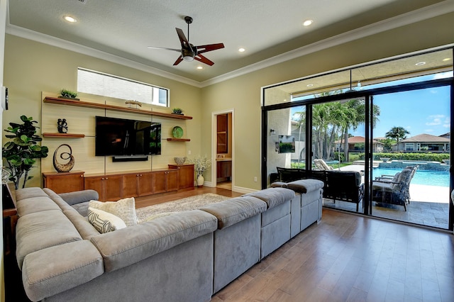 living room featuring recessed lighting, crown molding, and wood finished floors