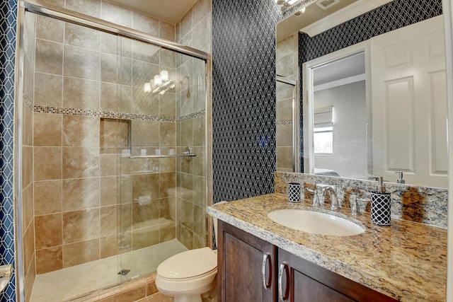 bathroom with visible vents, a stall shower, toilet, and vanity