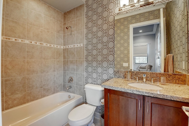 full bath featuring vanity, washtub / shower combination, and toilet