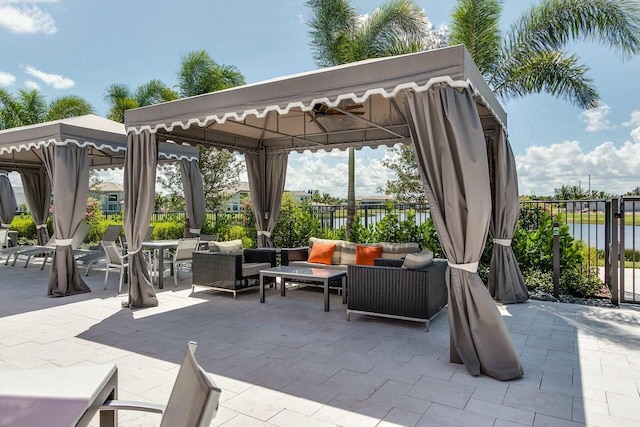 view of patio / terrace featuring a gazebo, fence, and an outdoor living space