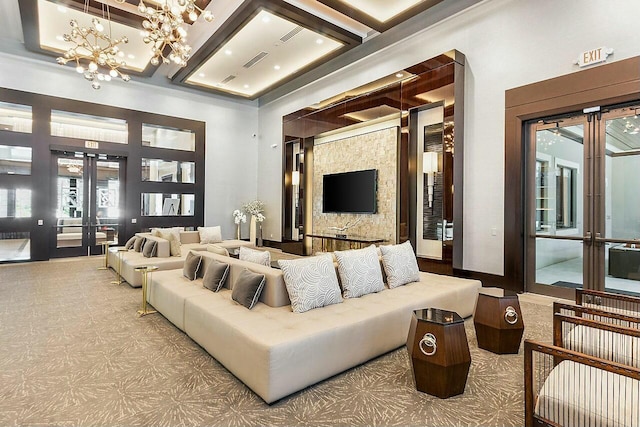 living area featuring visible vents, plenty of natural light, french doors, and coffered ceiling