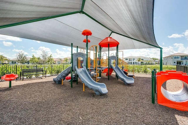 community jungle gym featuring a residential view and fence